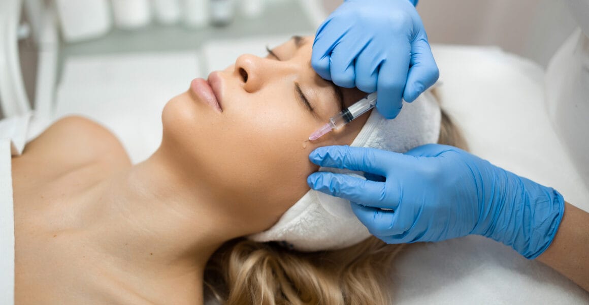 Woman face during beauty injection. Rejuvenating and anti aging treatments